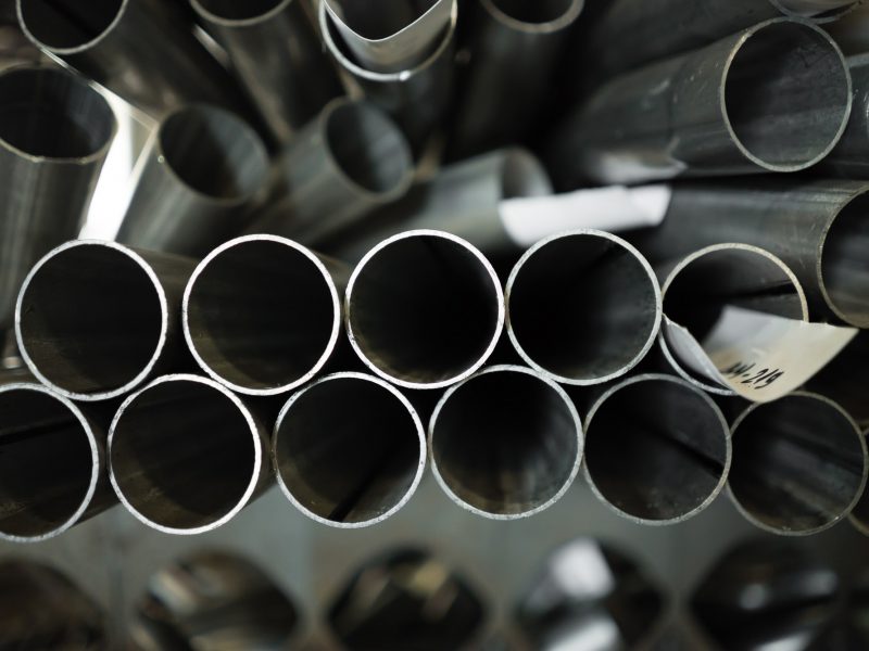 round pipes stacked in disarray